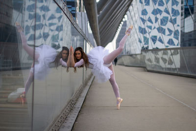 Full length of woman dancing on bridge