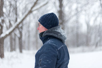 Man in warm clothing on snow covered land