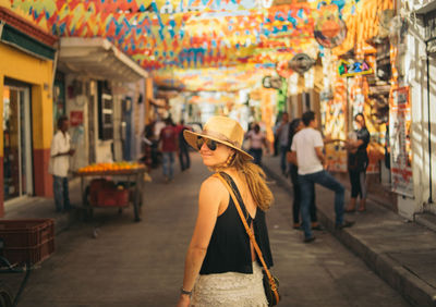 Rear view of woman walking on street in city