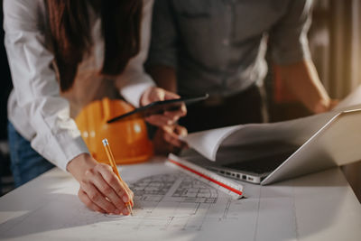 Midsection of woman working on table