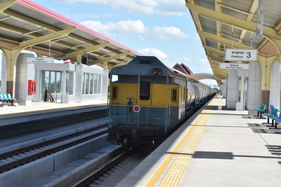 Train at railroad station against sky