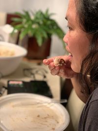 Side view of woman holding food