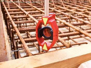 Close-up of red bell hanging on railing