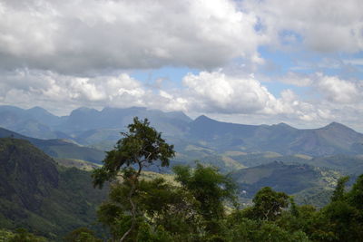 Scenic view of mountains against cloudy sky