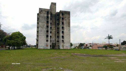 View of lawn against cloudy sky