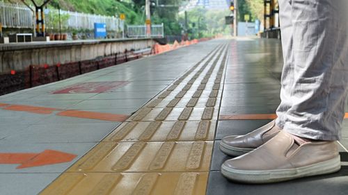 Low section of person standing on road