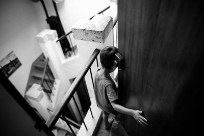 High angle view of boy standing by door