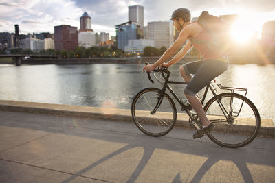 Low section of man riding bicycle on street