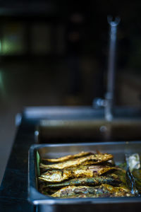 Close-up of marinated fish in tray