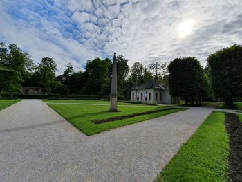 Lawn by building against sky