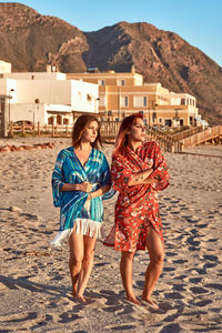 Two girls in kimonos on the beach. fashion concept