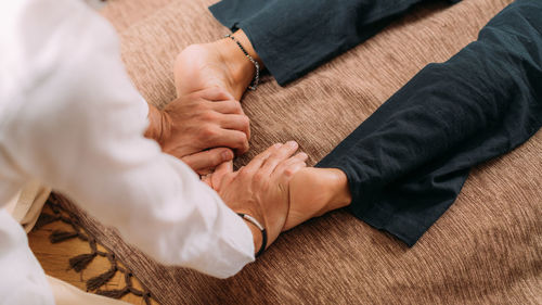 Shiatsu foot massage. therapist massaging the kidney meridian.