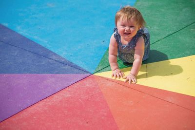 Baby girl on colorful footpath