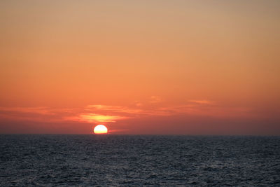 Scenic view of sea against romantic sky at sunset