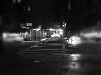 Illuminated city street at night