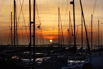 Sailboats moored at sunset