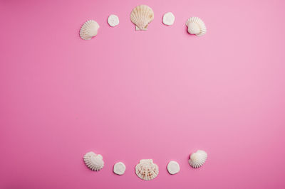 High angle view of pink toys against colored background