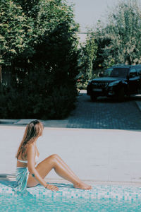 Young woman sitting on street