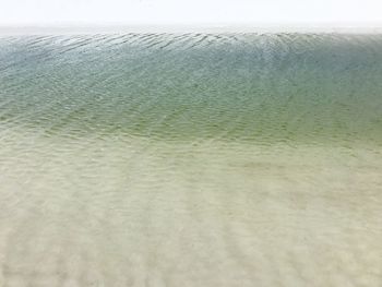 Close-up of beach against sky