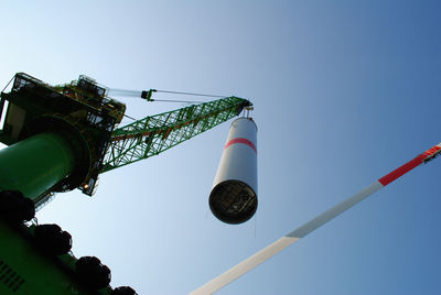 Low angle view of crane lifting column