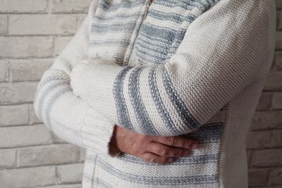 Close-up of woman with hand on snow