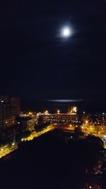 High angle view of illuminated buildings against sky at night