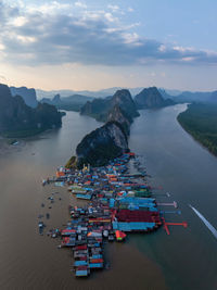 High angle view of city by sea against sky