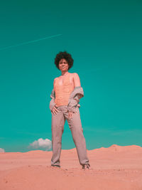 Full length of young man standing on beach