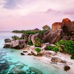 Rocks on sea shore against sky during sunset, seychelles tropical island 