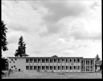 Exterior of ruined industry against cloudy sky