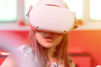 Vr game virtual reality. kid girl gamer playing on futuristic simulation video game in 3d glasses