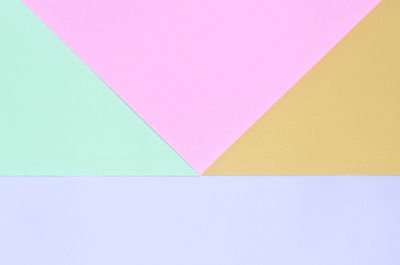 High angle view of multi colored paper against blue background
