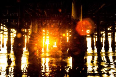 People in illuminated water at night