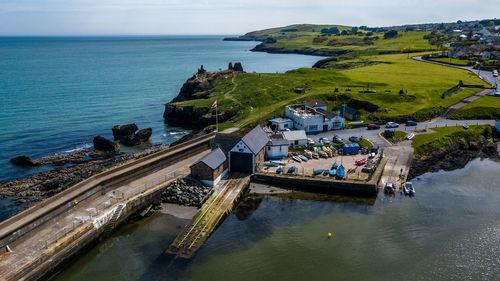 High angle view of houses in town against sea