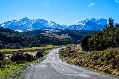 Road amidst mountains against sky