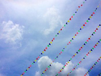 Low angle view of multi colored umbrellas against sky