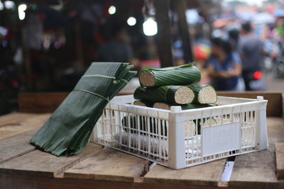 Close-up of food wrapped in banana leaves on wooden table