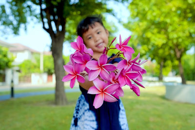 Young woman holding flowers