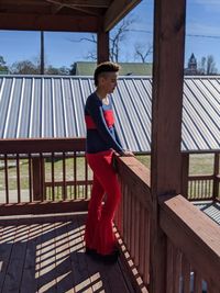 Full length of woman standing on railing