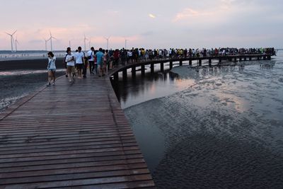 Pier on sea at sunset