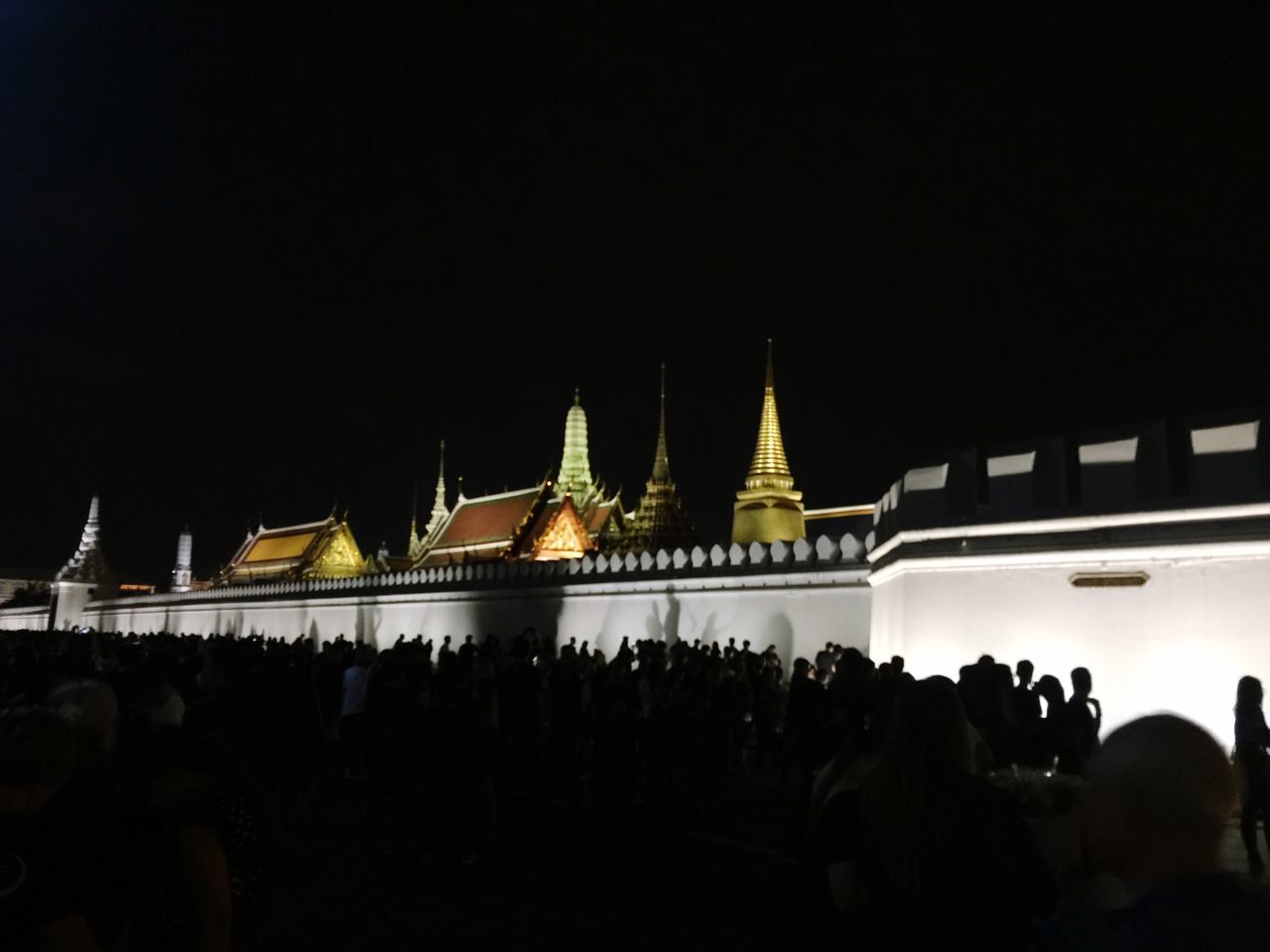 night, building exterior, illuminated, large group of people, tourism, architecture, travel destinations, built structure, copy space, tourist, famous place, sky, person, outdoors, vacations, place of worship, crowd, international landmark, multi colored, city life