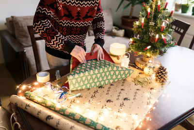 Young man packs christmas presents for friends and family