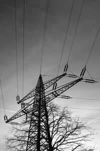 Low angle view of electricity pylon against sky