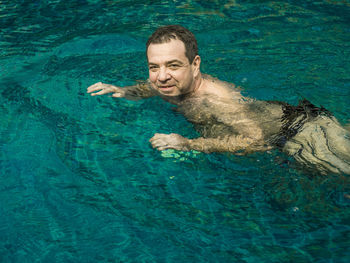 Portrait of man swimming in pool