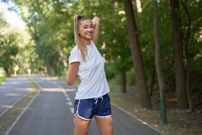 Full length of a smiling young woman outdoors