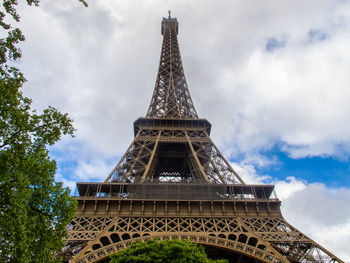 Low angle view of tower against cloudy sky