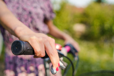 Midsection of woman standing with bicycle