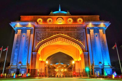 Low angle view of illuminated building at night