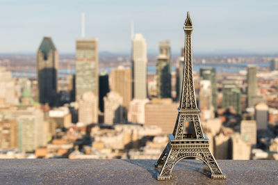 Close-up of eiffel tower against cityscape
