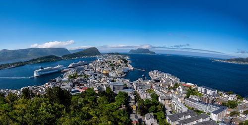 High angle view of city by sea against sky